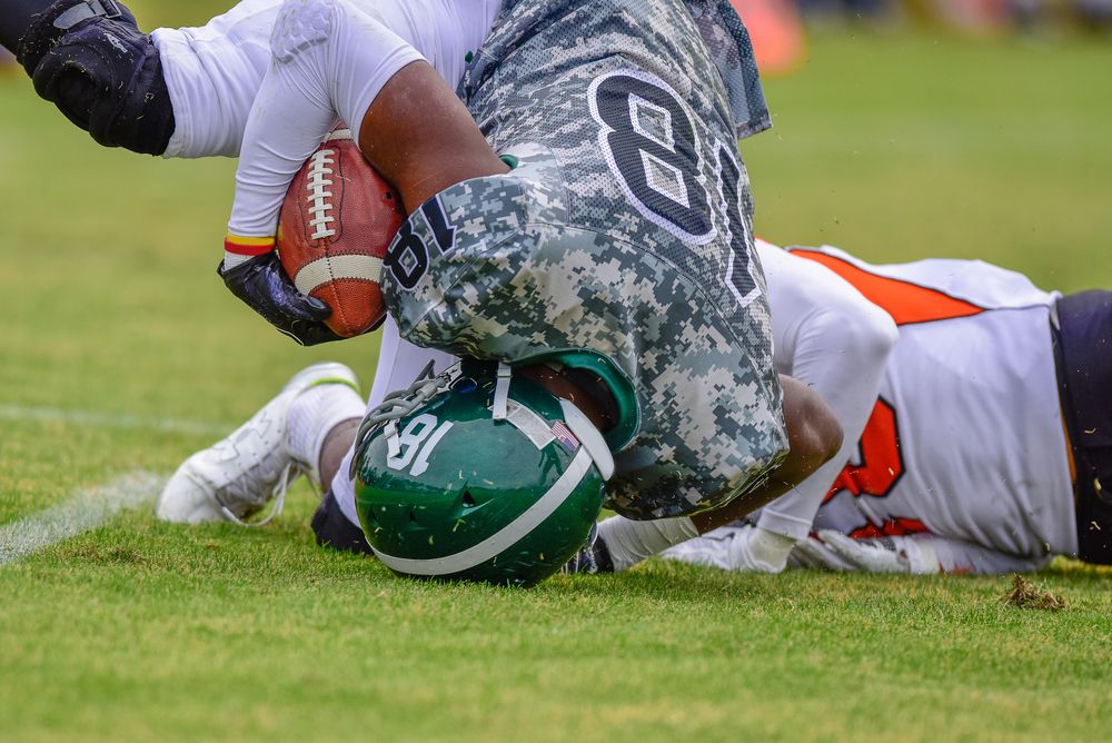 Football athlete landing on his neck and head